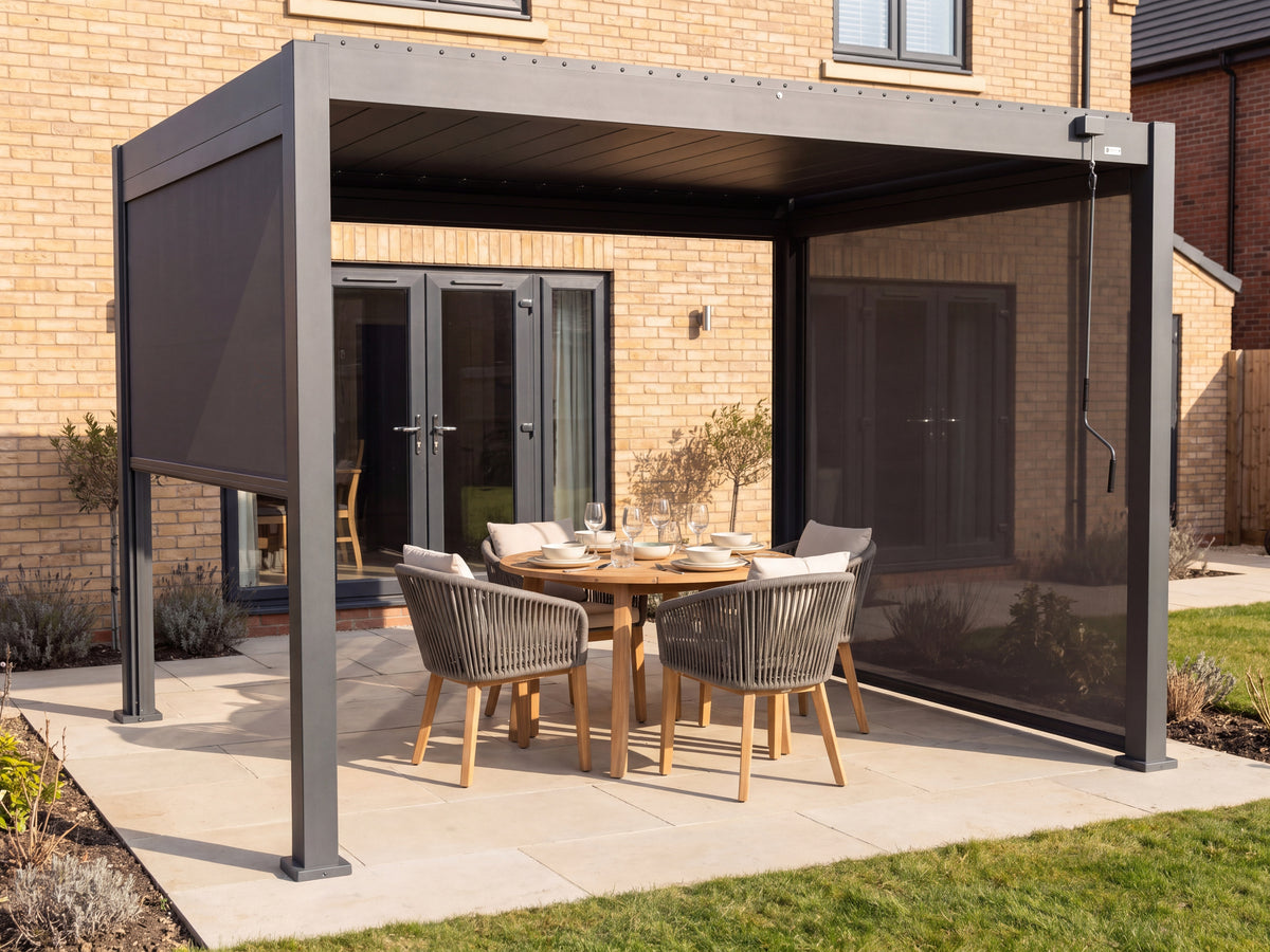 LuxSol Aura 3x4 · Refined round-table dining · Closed roof, left screen partly lowered and rear/right screened · Round teak table and rope chairs · Furniture and optional accessories shown for styling