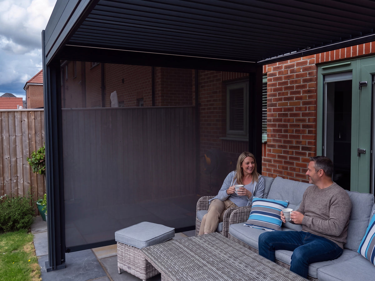 People relaxing with coffee under a Como pergola