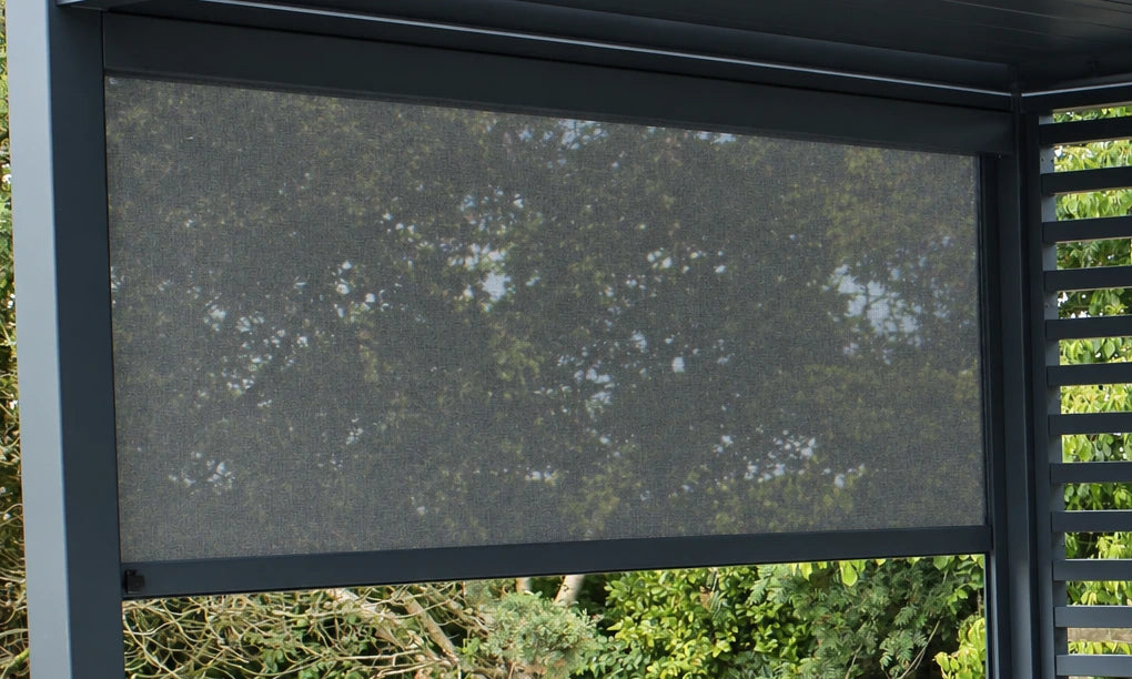 Partially lowered fabric privacy screen on a Como pergola, showing the cassette and bottom rail