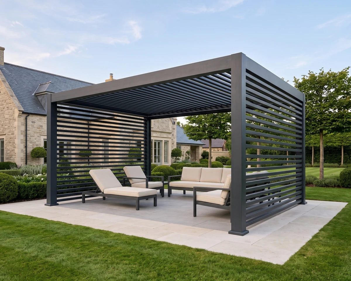 Tora pergola with slatted side walls styled as an outdoor lounge in a landscaped garden