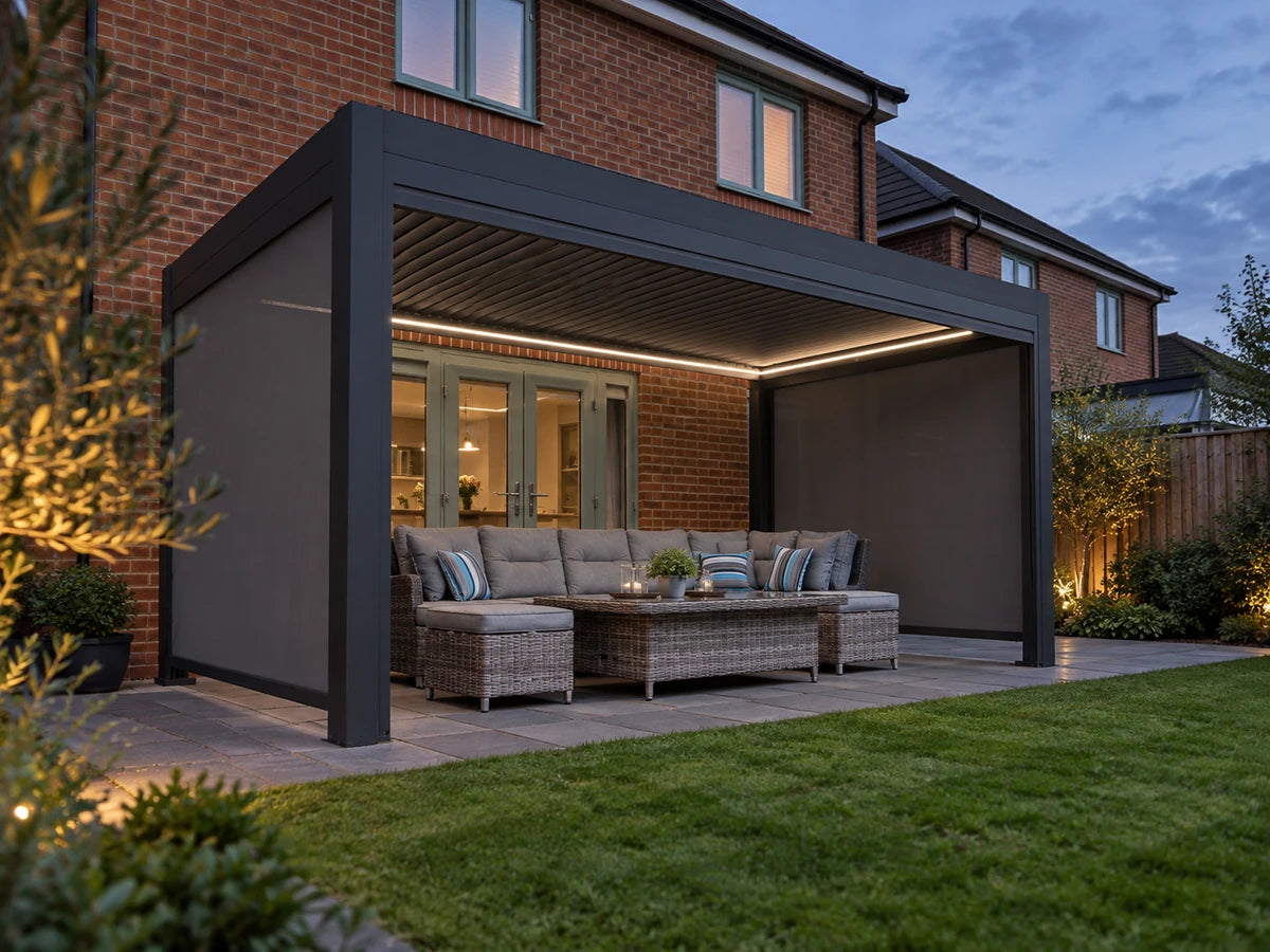 Como pergola with subtle white perimeter lighting beside a brick house at dusk