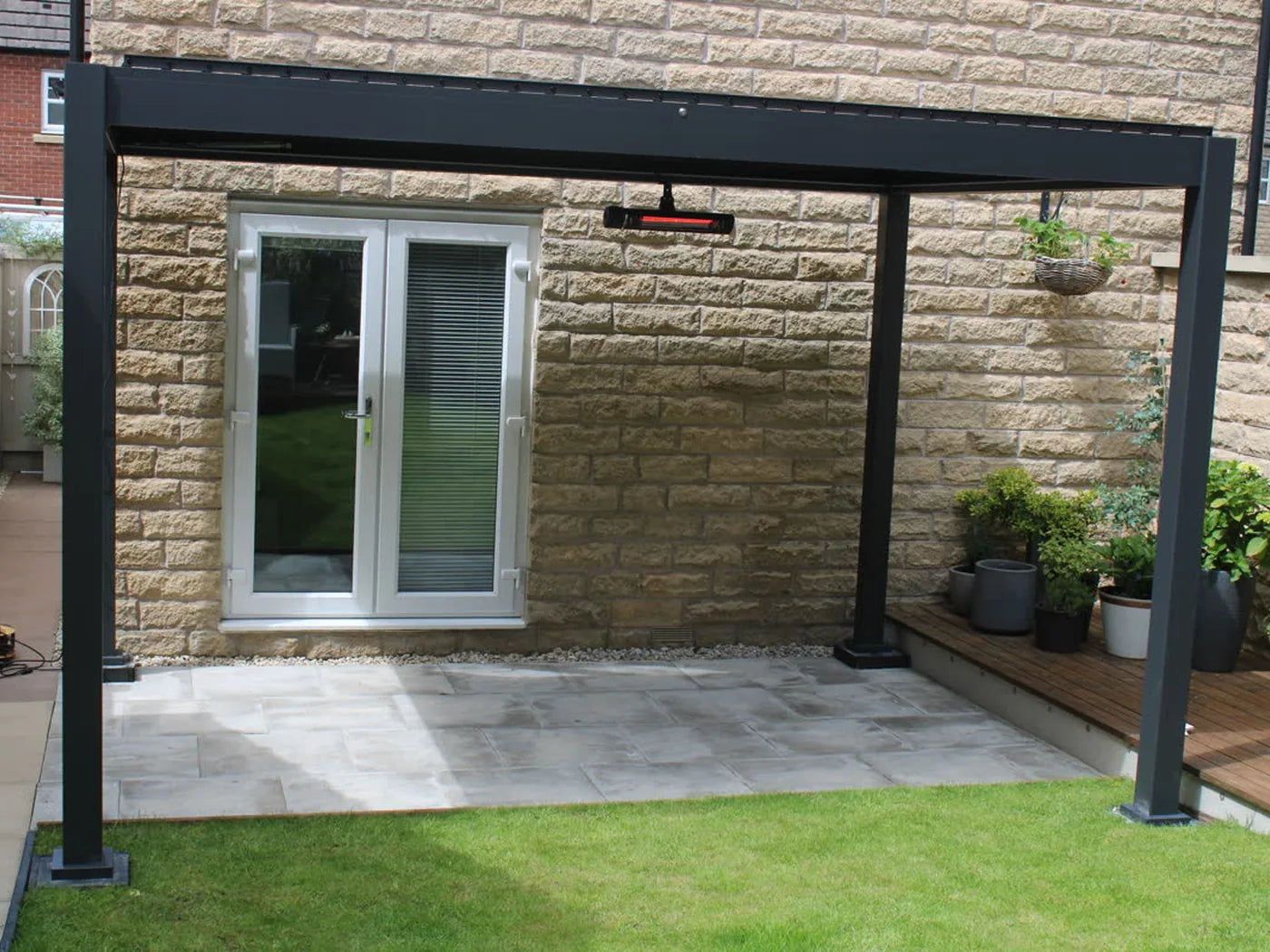 Como pergola on a patio beside a stone house