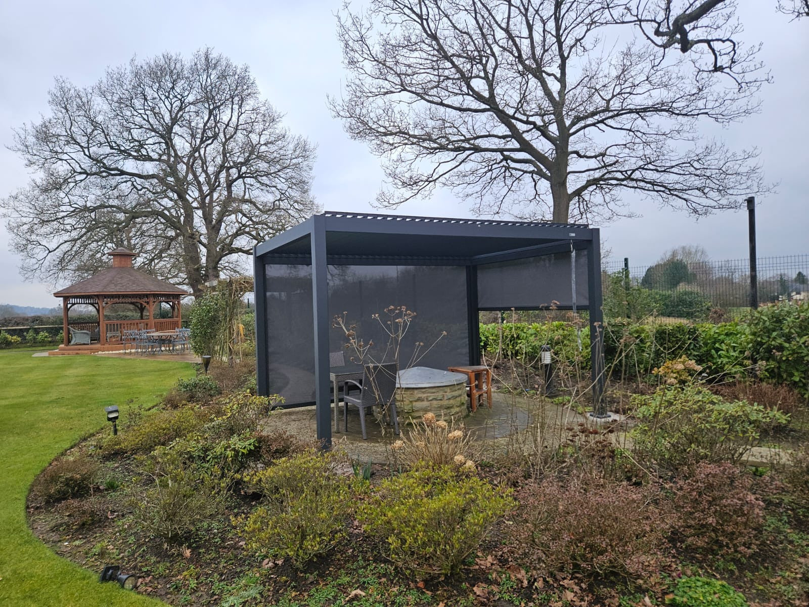 Real garden view showing a lowered screen across the pergola side