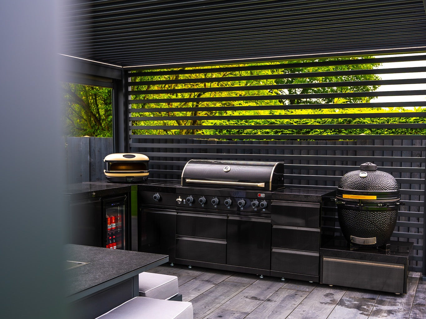 Real slatted wall providing a backdrop to an outdoor kitchen
